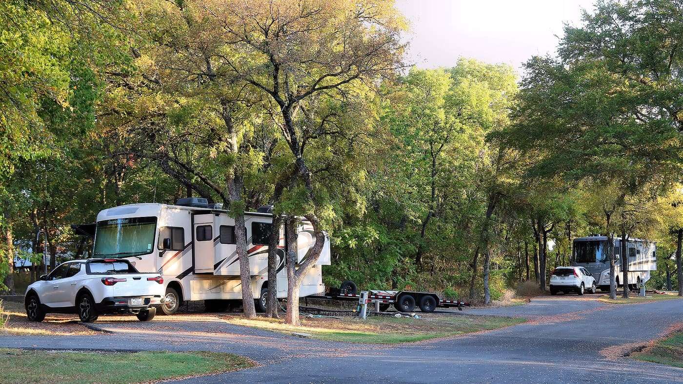 Recreational vehicles setup in the Bois d'Arc Ridge Camping Area in Eisenhower State Park in Grayson County, Texas. This camping area offers full hookups for ov
