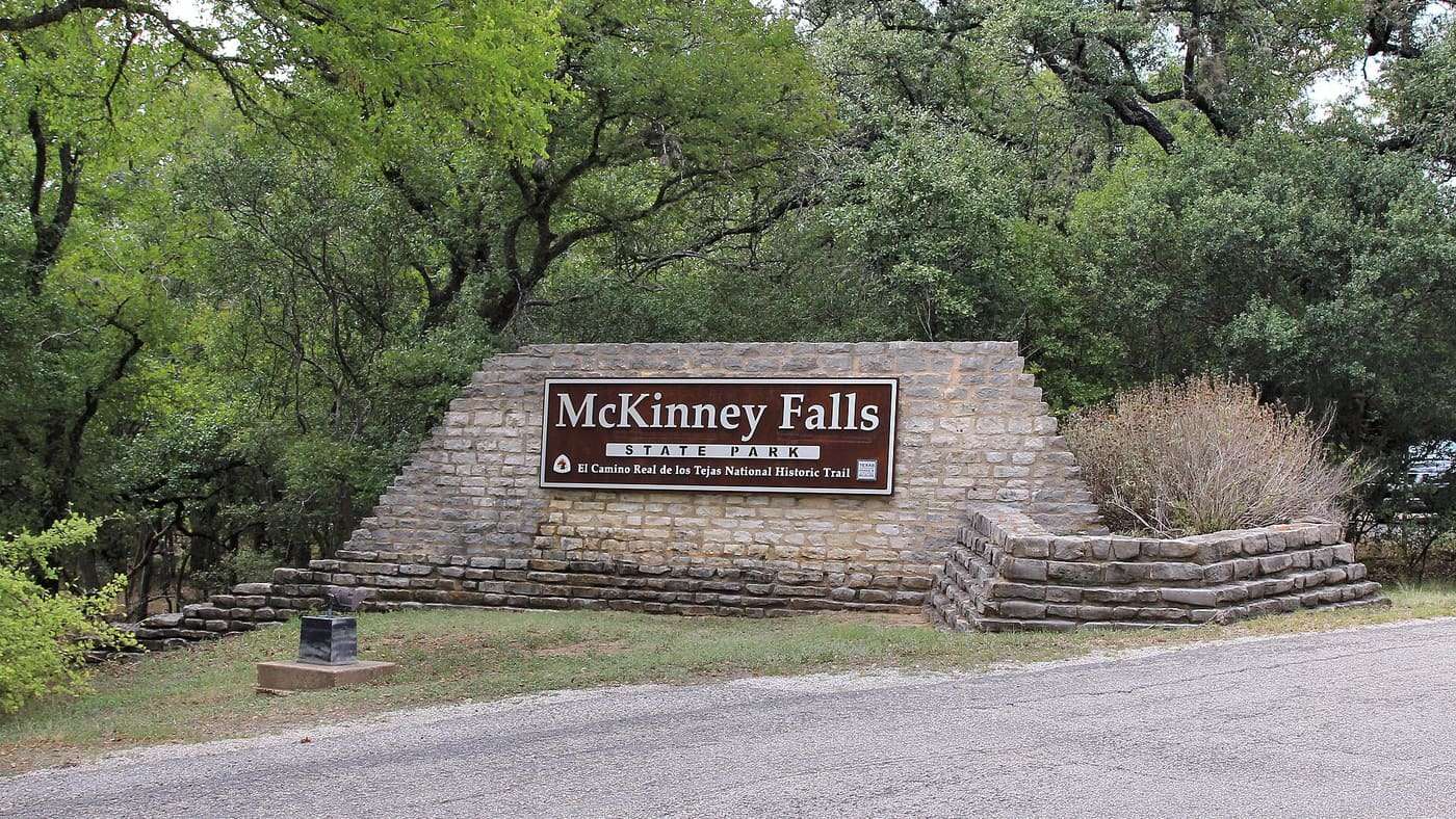 McKinney Falls State Park entrance sign in Austin, Texas, United States. The park is on the El Camino Real de los Tejas National Historic Trail.