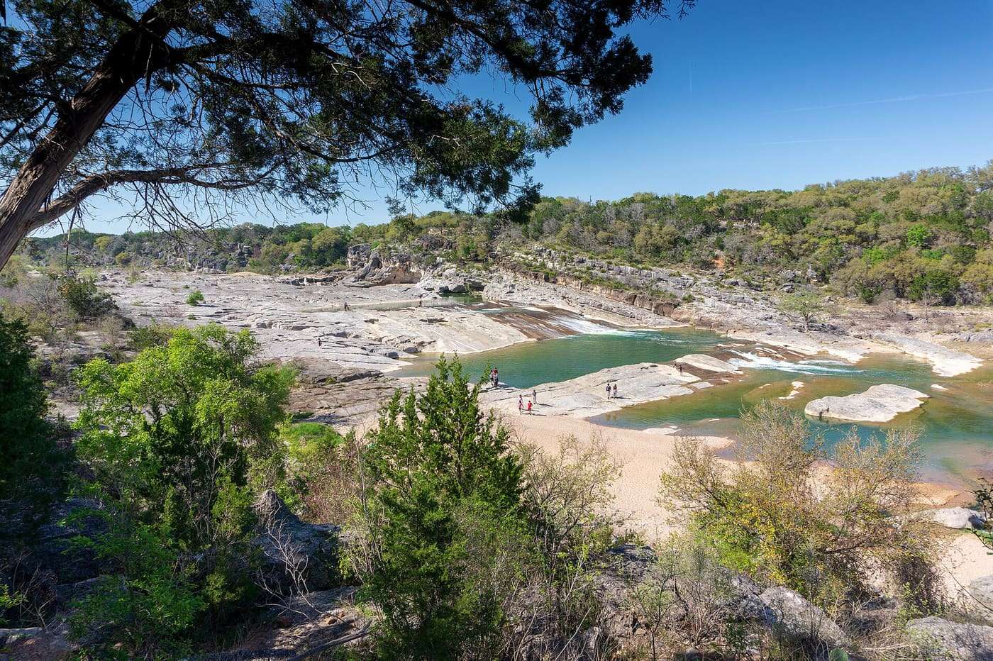 Pedernales river flows over limestone and creates these cascading falls , located near Johnson City, Texas.
